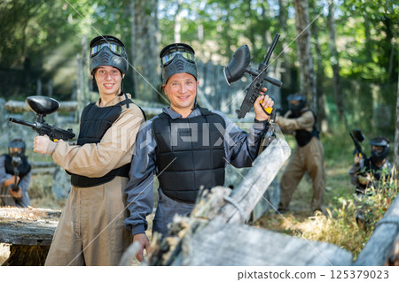 Two smiling paintball players in full gear having fun before game 125379023