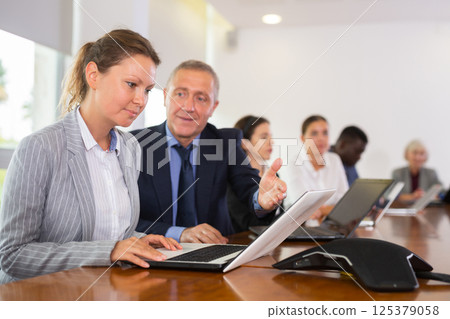 Young woman assistant talking with her boss during meeting 125379058