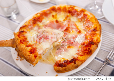 Delicious pizza with prosciutto Delicious pizza with prosciutto 125379186