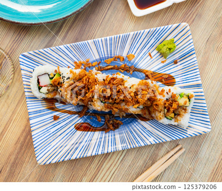 Curry roll - rolls with avocado, crab, cucumber and fried onion. Japanese traditional food Curry roll - rolls with avocado, crab, cucumber and fried onion. Japanese traditional food 125379206