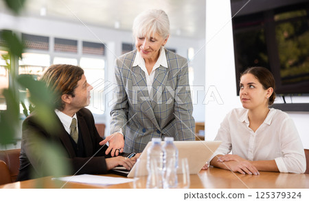 Adult man, elderly and young women having meeting in office 125379324