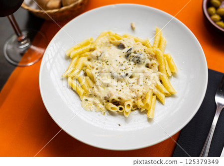 Delicious pasta served in mushroom sauce on platter Delicious pasta served in mushroom sauce on platter 125379349