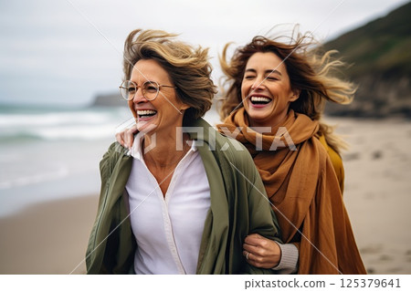 Oceanic Bonds Joyful Embrace of Two Women on a Breezy Beach, Laughter Echoing Waves, Windswept Hair, and Warm Scarves Unveiling Deep Connections. created with Generative AI 125379641