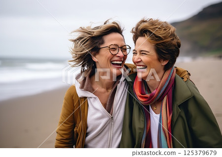 Oceanic Bonds Joyful Embrace of Two Women on a Breezy Beach, Laughter Echoing Waves, Windswept Hair, and Warm Scarves Unveiling Deep Connections. created with Generative AI 125379679