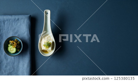 Culinary Serenity: Minimalist close-up of an Asian-inspired dish presented in a refined, contemporary composition, evoking a sense of calm and culinary artistry. 125380135