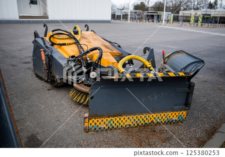 street sweeper brush and plow attachments with hydraulic hoses, concept of urban maintenance tools 125380253