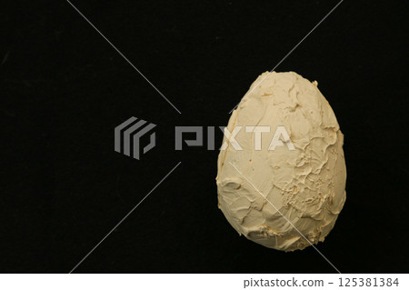 Close-up of a homemade plaster egg. 125381384