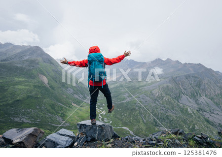 Hiking woman on high altitude mountain top 125381476