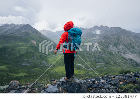 Hiking woman on high altitude mountain top 125381477