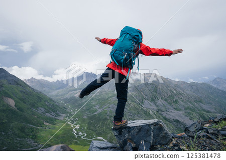 Hiking woman on high altitude mountain top 125381478