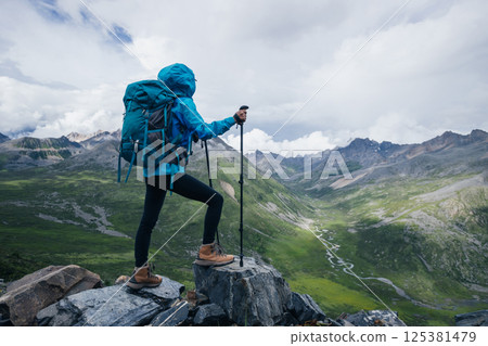 woman hiking on high altitude mountain top woman hiking on high altitude mountain top 125381479