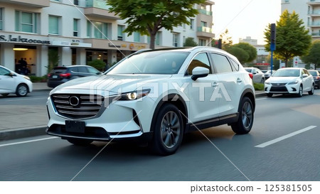 white car drives on city street among other vehicles in front of modern apartment buildings, concept of urban mobility, automotive sales, transportation service 125381505