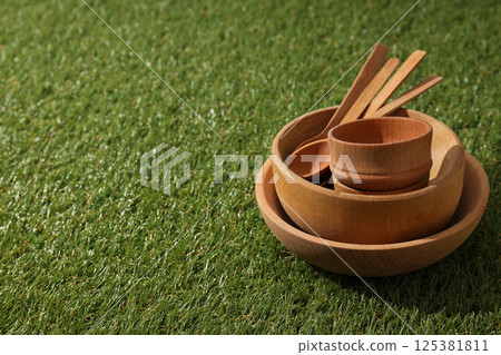 Reusable tableware made of wood on grass. Reusable tableware made of wood on grass. 125381811