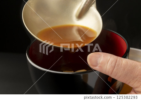 Miso soup with red miso, clams and tofu served in a bowl 125382293