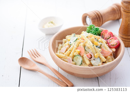 Macaroni salad served in a wooden bowl Macaroni salad served in a wooden bowl 125383113