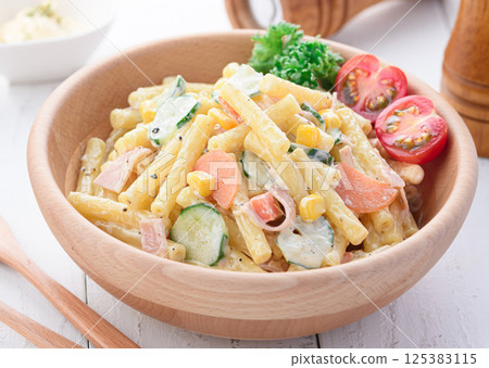 Macaroni salad served in a wooden bowl Macaroni salad served in a wooden bowl 125383115