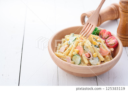 Macaroni salad served in a wooden bowl Macaroni salad served in a wooden bowl 125383119