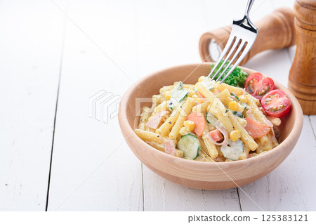 Macaroni salad served in a wooden bowl Macaroni salad served in a wooden bowl 125383121