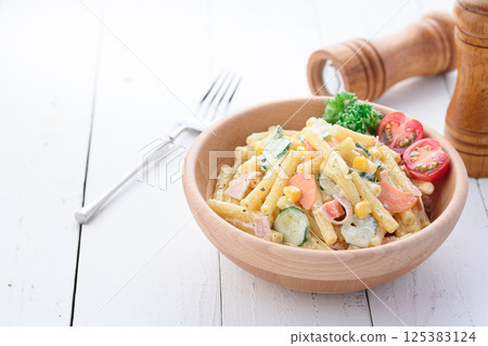 Macaroni salad served in a wooden bowl Macaroni salad served in a wooden bowl 125383124