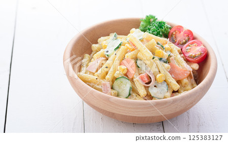 Macaroni salad served in a wooden bowl 125383127