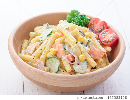 Macaroni salad served in a wooden bowl 125383128