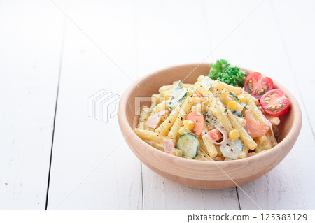 Macaroni salad served in a wooden bowl 125383129