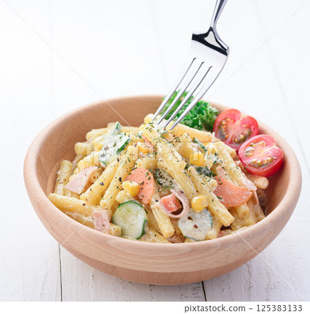 Macaroni salad served in a wooden bowl Macaroni salad served in a wooden bowl 125383133