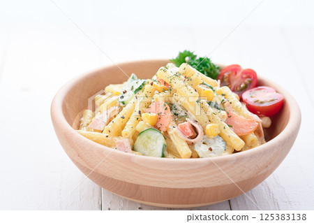 Macaroni salad served in a wooden bowl Macaroni salad served in a wooden bowl 125383138