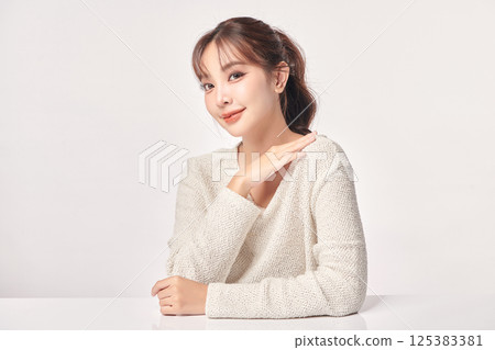 A beautiful young Asian woman with clean, fresh skin against a white background. Skincare, facial treatment, cosmetology, beauty, and spa. An elegant portrait of an Asian woman. A beautiful young Asian woman with clean, fresh skin against a white background. Skincare, facial treatment, cosmetology, beauty, and spa. An elegant portrait of an Asian woman. 125383381