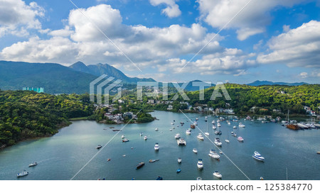 April 21 2025 Scenic Harbor View With Boats Anchored Under a Vibrant Sky 125384770