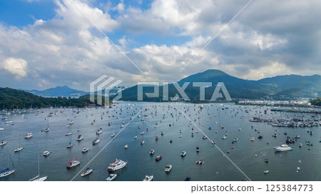 April 21 2025 Scenic Harbor View With Boats Anchored Under a Vibrant Sky 125384773