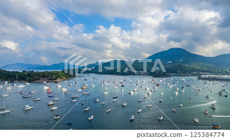 April 21 2025 Scenic Harbor View With Boats Anchored Under a Vibrant Sky 125384774