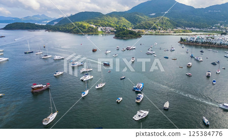 April 21 2025 Scenic Harbor View With Boats Anchored Under a Vibrant Sky 125384776