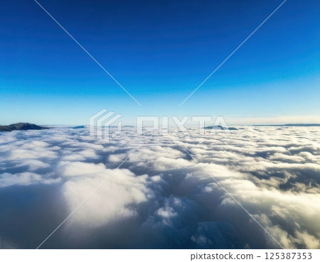 Blue sky and sea of clouds (AI generated image) 125387353