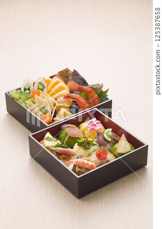 Cherry blossom viewing bento with temari sushi 125387658