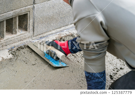 A plasterer is a craftsman who finishes concrete. A plasterer is a craftsman who finishes concrete. 125387779