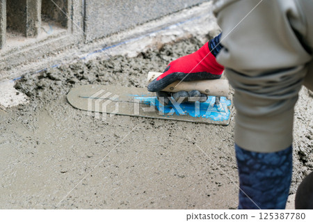 A plasterer is a craftsman who finishes concrete. 125387780