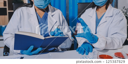 Researcher using a professional microscope Researcher using a professional microscope 125387829
