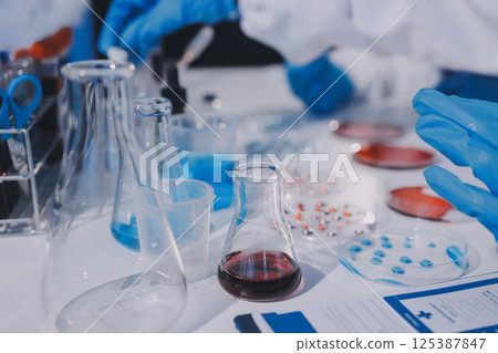 Researcher using a professional microscope 125387847