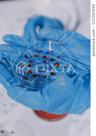 Researcher using a professional microscope Researcher using a professional microscope 125387849