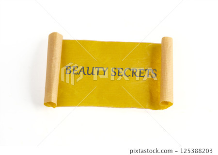 A beautifully crafted scroll displays the text beauty secrets, representing ancient wisdom passed down for glowing skin and hair care. This piece evokes interest in natural beauty A beautifully crafted scroll displays the text beauty secrets, representing ancient wisdom passed down for glowing skin and hair care. This piece evokes interest in natural beauty 125388203