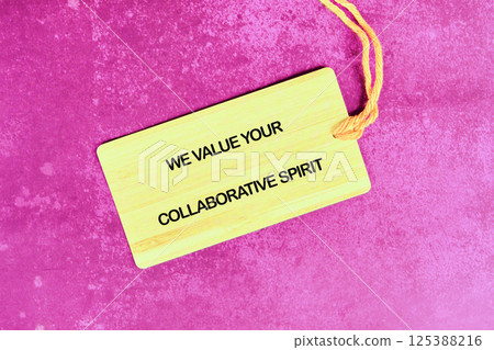 Collaborative spirit emphasized through a wooden tag on a vibrant pink background Collaborative spirit emphasized through a wooden tag on a vibrant pink background 125388216