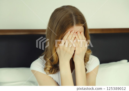 Upset sad crying woman while experiencing mental suffering, depression, fatigue, emotional stress 125389012
