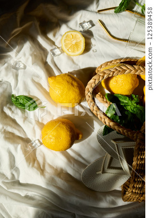 Bright summer lemons in a woven bag on a soft cloth in Italy Bright summer lemons in a woven bag on a soft cloth in Italy 125389458