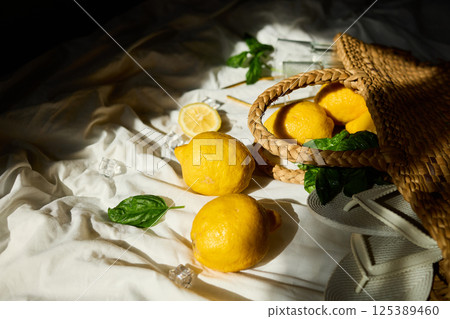 Bright summer lemons in a woven bag on a soft cloth in Italy Bright summer lemons in a woven bag on a soft cloth in Italy 125389460