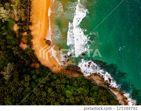 Top view seashore waves nature background,Amazing waves crashing on rocks seascape view 125389702
