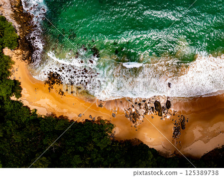 Top view seashore waves nature background,Amazing waves crashing on rocks seascape view 125389738