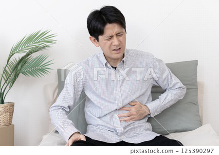 Man with stomach ache, stomach ache, gastroenteritis, diarrhea, constipation 125390297