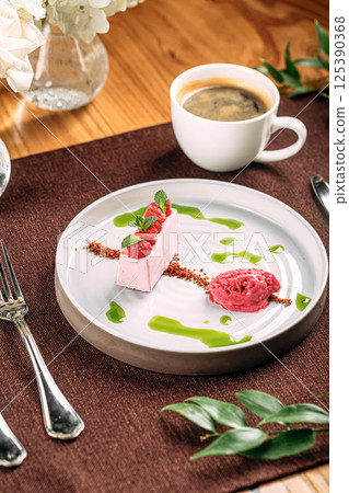 Portion of pink raspberry mousse dessert Portion of pink raspberry mousse dessert 125390368