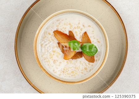 Portion of breakfast porridge cereals with peach 125390375